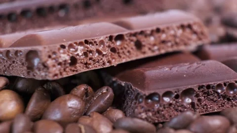 Close-up of dark roasted coffee beans and chocolate on rotating table. Stock Footage 140107917