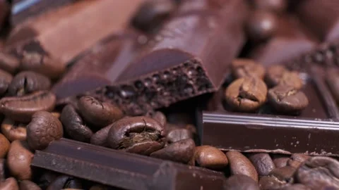 Close-up of dark roasted coffee beans and chocolate on rotating table. Stock Footage 140208307