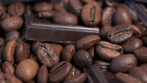 Close-up of dark roasted coffee beans and chocolate on rotating table. Stock Footage 140210173