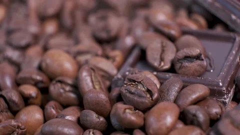 Close-up of dark roasted coffee beans and chocolate on rotating table. Stock Footage 140704622