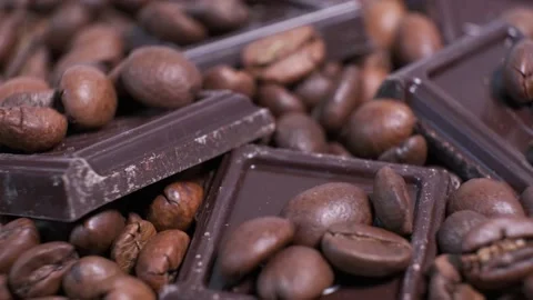 Close-up of dark roasted coffee beans and chocolate on rotating table. Stock Footage 140819518