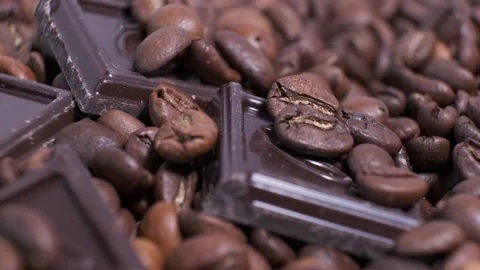 Close-up of dark roasted coffee beans and chocolate on rotating table. Stock Footage 140906003