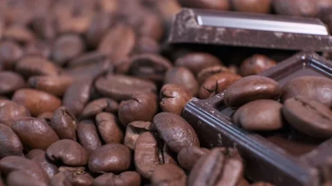 Close-up of dark roasted coffee beans and chocolate on rotating table. Stock Footage 141052784