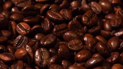 Close-up of dark roasted coffee beans spinning Stock Footage 160649147