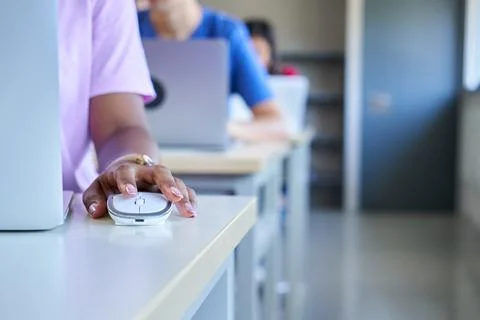Close up of dark skin hand using computer mouse at classroom, unrecognizable Stock Photos