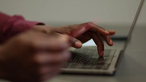 Close-up of dark-skinned hand holding a bank card and a man entering data for Stock Footage 262208009