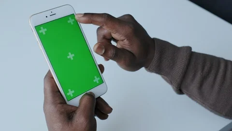 Close Up of Dark Skinned Hands with Green Screen. Colour Chroma Key or Mockup Stock Footage 120684312