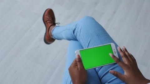 Close Up of Dark Skinned Hands with Green Screen. Colour Chroma Key or Mockup Stock Footage 121093067
