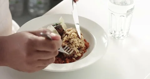 Close up of dark skinned man eating dinner Stock Footage 80553485