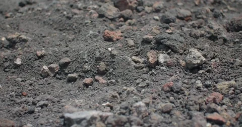 Close up of the dark volcanic dust and rocks on the ground, Etna Volcano, 4k Video stock 332715475