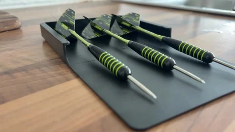 Close Up of Darts Lying on Table Before Indoor Game or Practice Stock Footage 337506524
