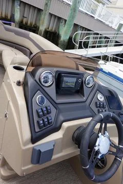 Close up of the dashboard control panel and steering wheel of a boat Stock Photos