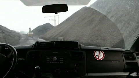 Close up of dashboard whilst driving though piles of coal 動画素材 667628