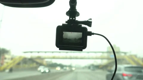 Close-up of a dashcam hanging on the windshield of a car recording the route of Stock Footage 158236497