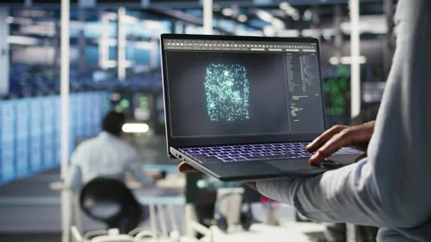 Close up of data center admin using machine learning algorithms on laptop Stock Footage 309125081