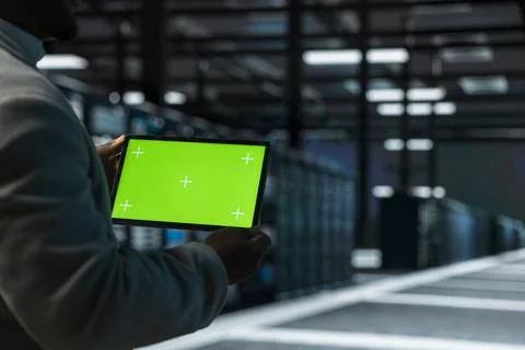Close up of data center admin using green screen tablet, doing checkup Stock Photos