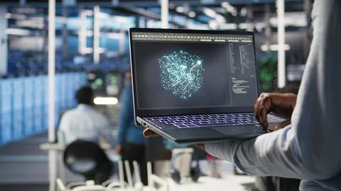 Close up of data center admin using machine learning algorithms on laptop 스톡 사진