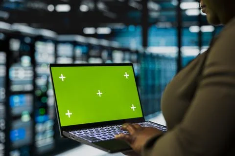 Close up of data center admin using green screen laptop to install equipment 写真素材