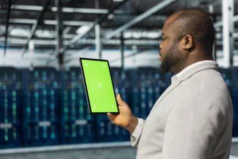 Close up of data center admin using green screen tablet in data center Stock Photos