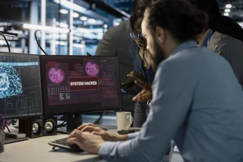 Close up of data center admins reacting to virus alert on PC monitor Stock Photos