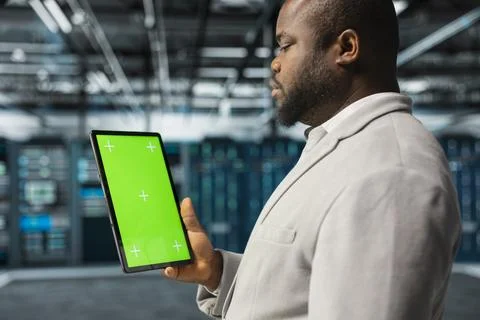 Close up of data center computer scientist using mockup tablet in data center Stock Photos