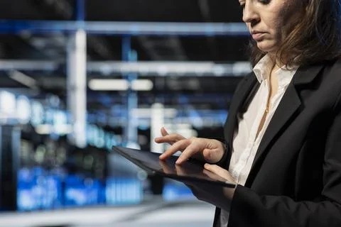 Close up of data center computer scientist using tablet app to modify settings Stock Photos
