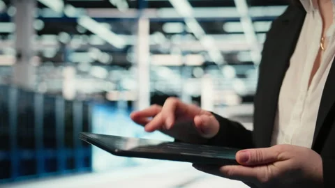 Close up of data center cybersecurity analyst using tablet to conduct audit Stock Footage 329330351