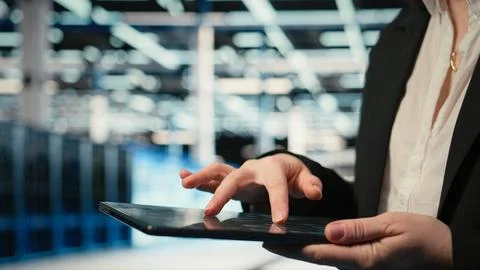 Close up of data center cybersecurity analyst using tablet to conduct audit Stock Photos