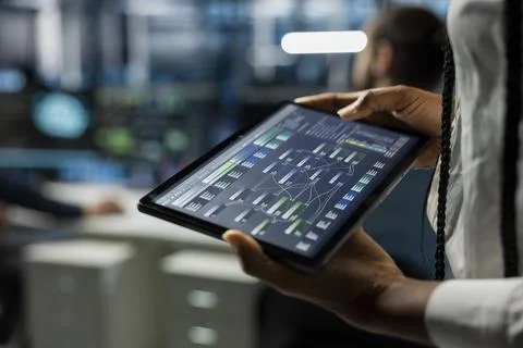 Close up of data center developer running AI forecasting simulations on tablet Foto stock