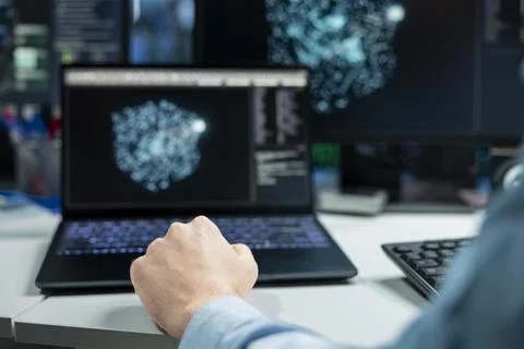 Close up of data center developer using laptop, monitoring AI systems 写真素材