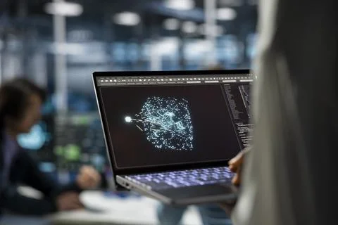 Close up of data center developer using laptop works on databases supporting AI Stock Photos