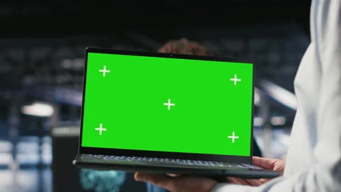 Close up of data center employee doing maintenance tasks on green screen laptop Stock Footage 310275944