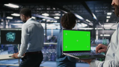 Close up of data center employee doing maintenance tasks on green screen laptop Stock Footage 310787112