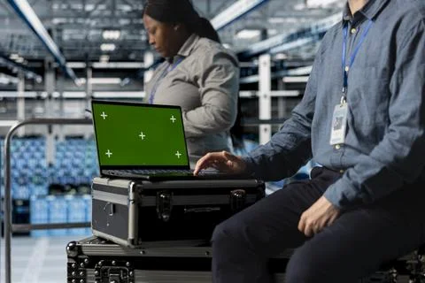 Close up of data center employee using green screen notebook 스톡 사진