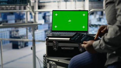 Close up of data center employees check AI dashboard using green screen tablet Stock Photos