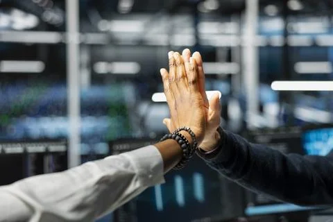 Close up of data center employees doing high five after upgrade systems using AI 写真素材