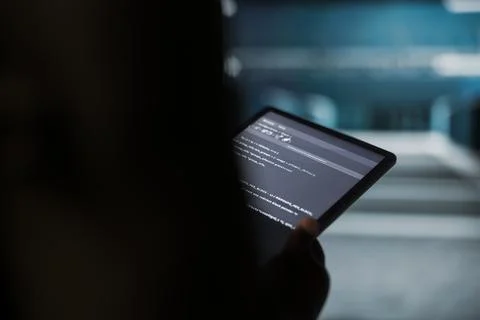 Close up of data center engineer conducting tests on equipment using tablet Stock Photos