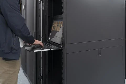 Close up on Data Center Engineer hands Using keyboard on a supercomputer Server Stock Photos