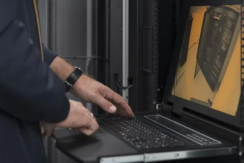 Close up on Data Center Engineer hands Using keyboard on a supercomputer Server 스톡 사진