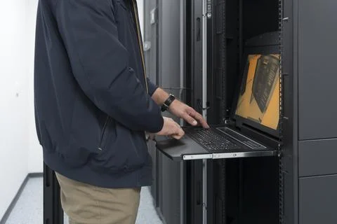 Close up on Data Center Engineer hands Using keyboard on a supercomputer Server 스톡 사진