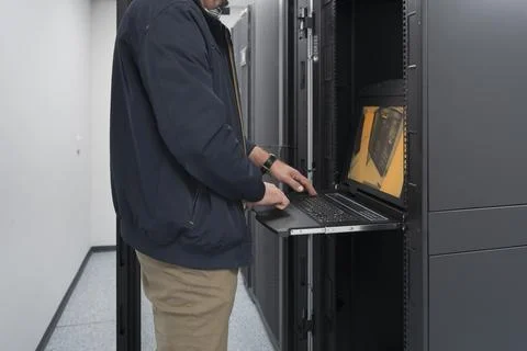 Close up on Data Center Engineer hands Using keyboard on a supercomputer Server 스톡 사진