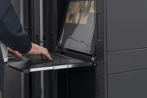 Close up on Data Center Engineer hands Using keyboard on a supercomputer Server Stock Photos