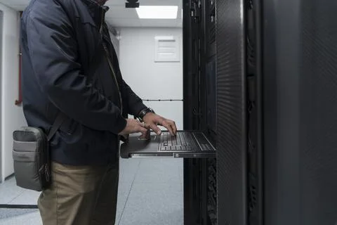 Close up on Data Center Engineer hands Using keyboard on a supercomputer Server 스톡 사진