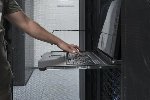 Close up on Data Center Engineer hands Using keyboard on a supercomputer Server Stock Photos