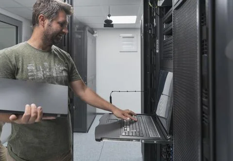 Close up on Data Center Engineer hands Using keyboard on a supercomputer Server Stock Photos