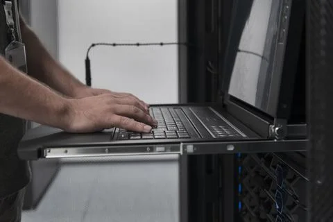 Close up on Data Center Engineer hands Using keyboard on a supercomputer Server 스톡 사진