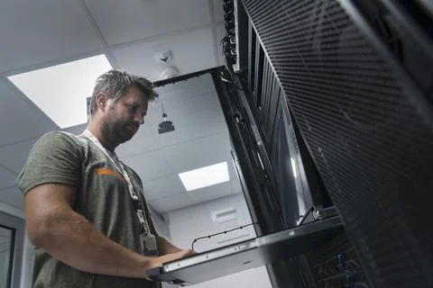 Close up on Data Center Engineer hands Using keyboard on a supercomputer Server 스톡 사진