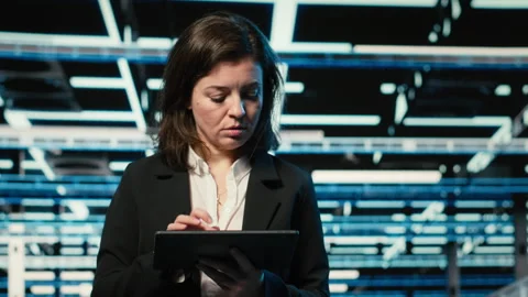 Close up of data center engineer optimizing server load balancing using tablet Stock Footage 329333642