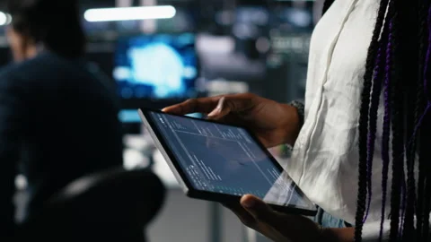 Close up of data center engineer using tablet to review code Stock Footage 313636650