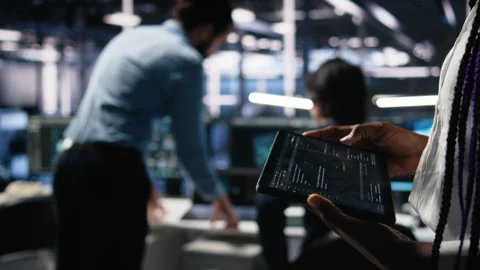 Close up of data center engineer using tablet to review code 動画素材 313637756